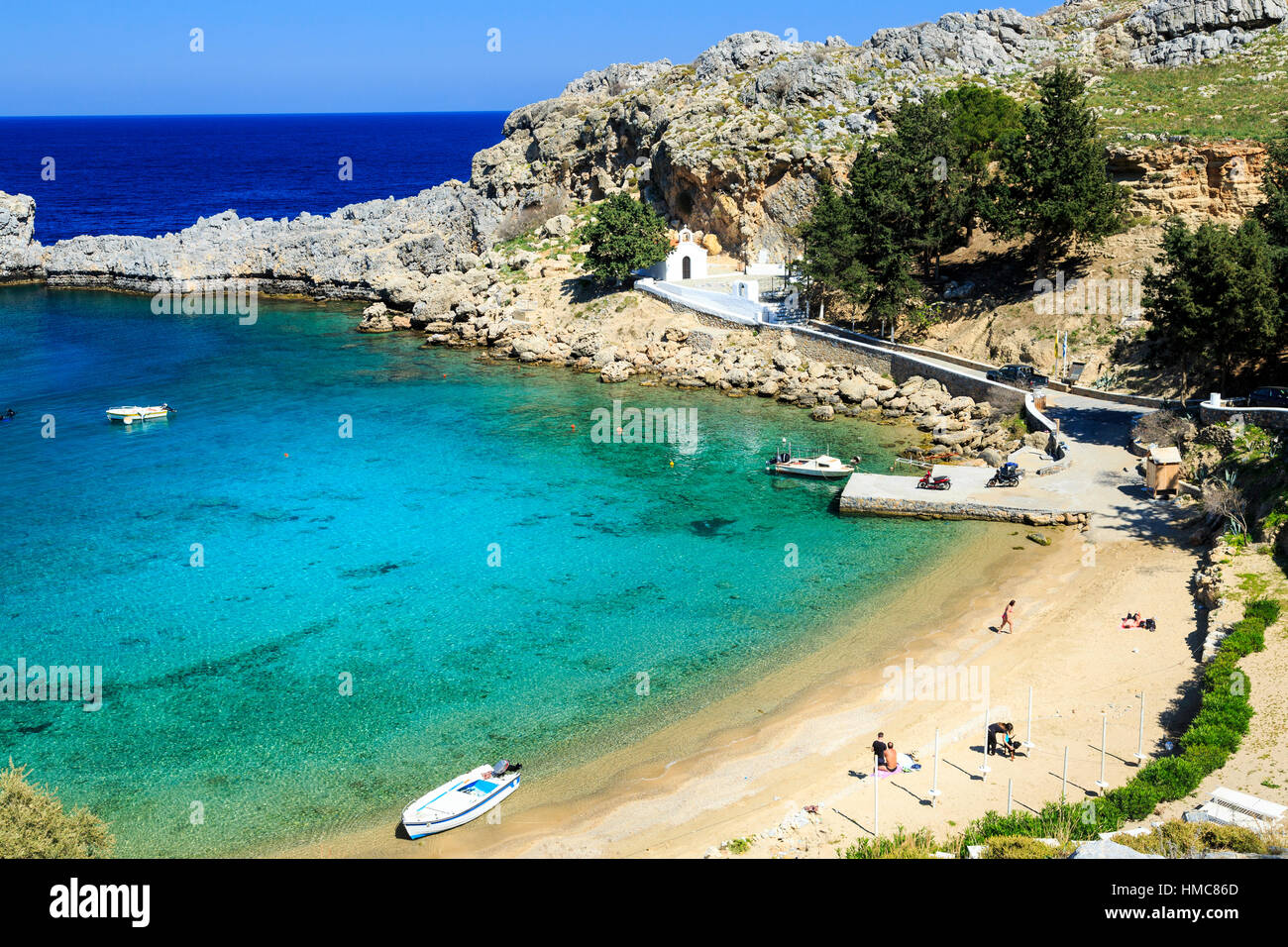 St Pauls Bay and Beach with Lindos Acropolis in the background, rhodes, greece Stock Photo