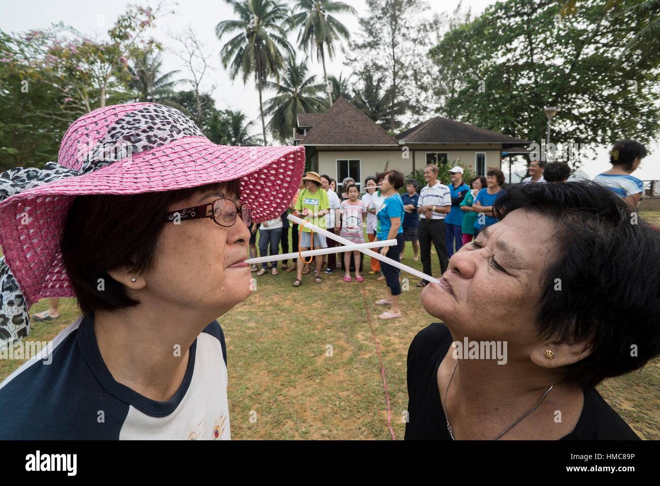 Passing the rubber band with straw by mouth game played at Retreats