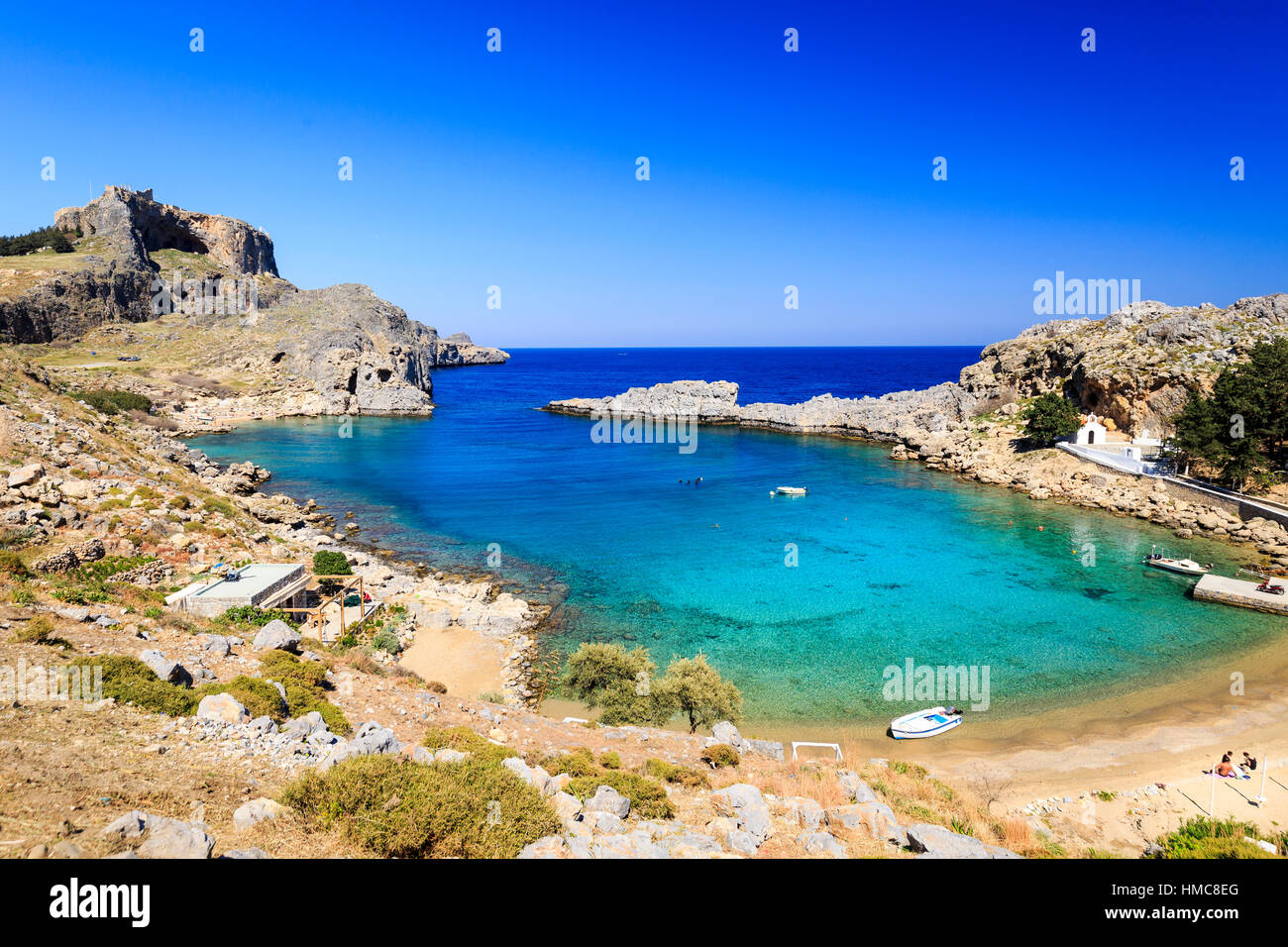 St Pauls Bay and Beach with Lindos Acropolis in the background, rhodes, greece Stock Photo