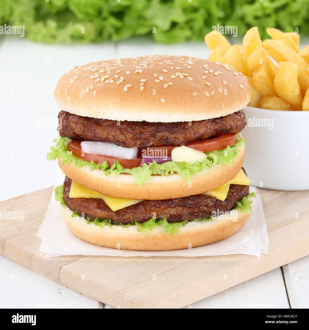 Double burger hamburger and fries beef tomatoes lettuce cheese unhealthy Stock Photo