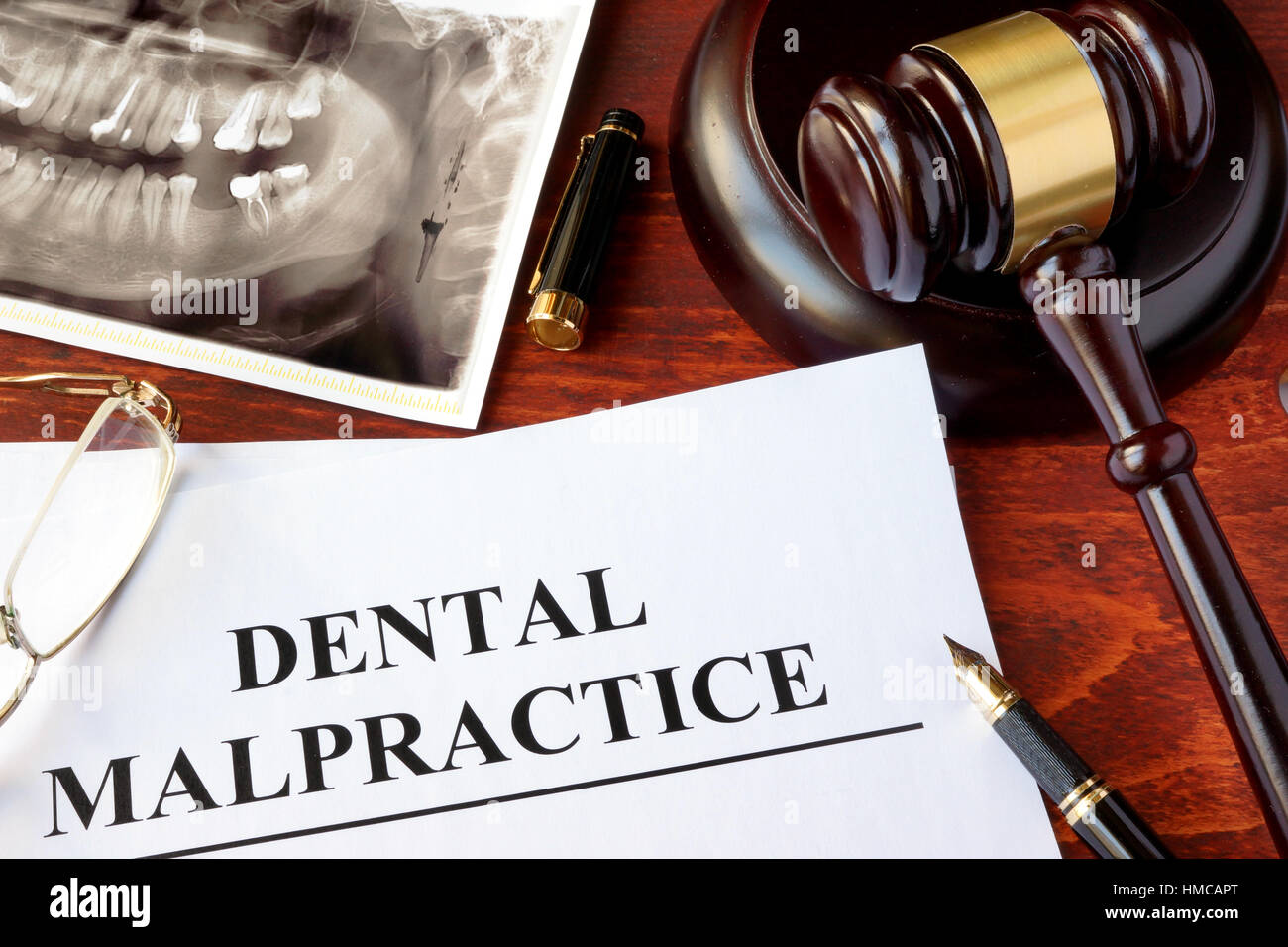 Dental Malpractice form, and gavel on a surface. Stock Photo
