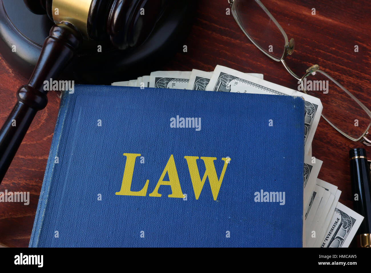 Book with Law, a gavel and cash. Corruption in a court concept. Stock Photo
