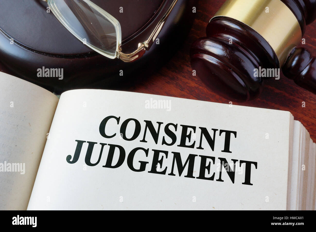 Book with chapter Consent judgement and a gavel. Stock Photo