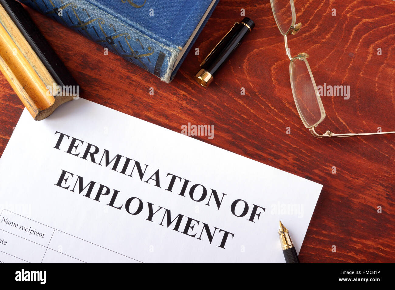 Termination of employment form on a wooden surface. Stock Photo