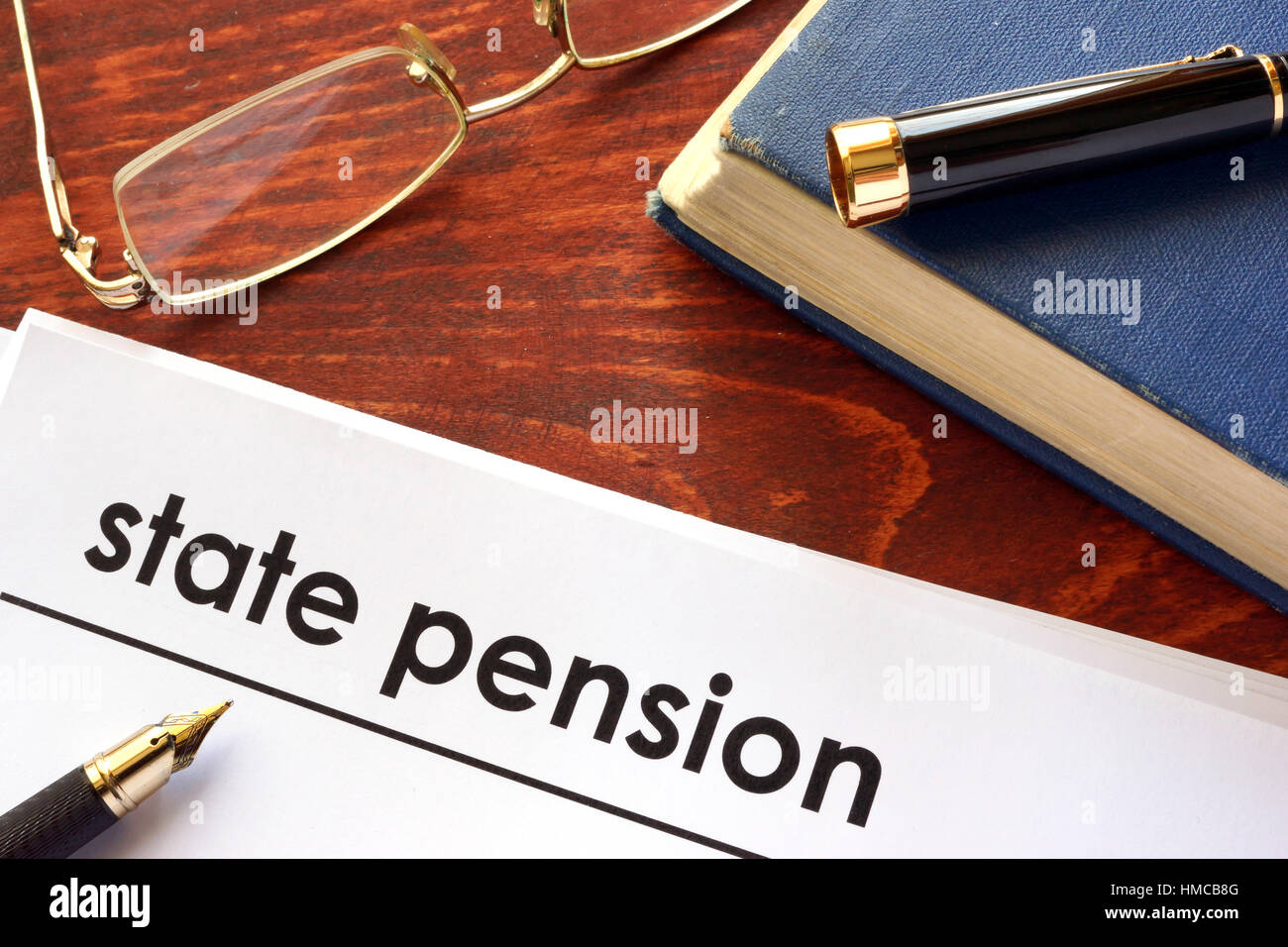 Paper with title state pension on a table. Stock Photo