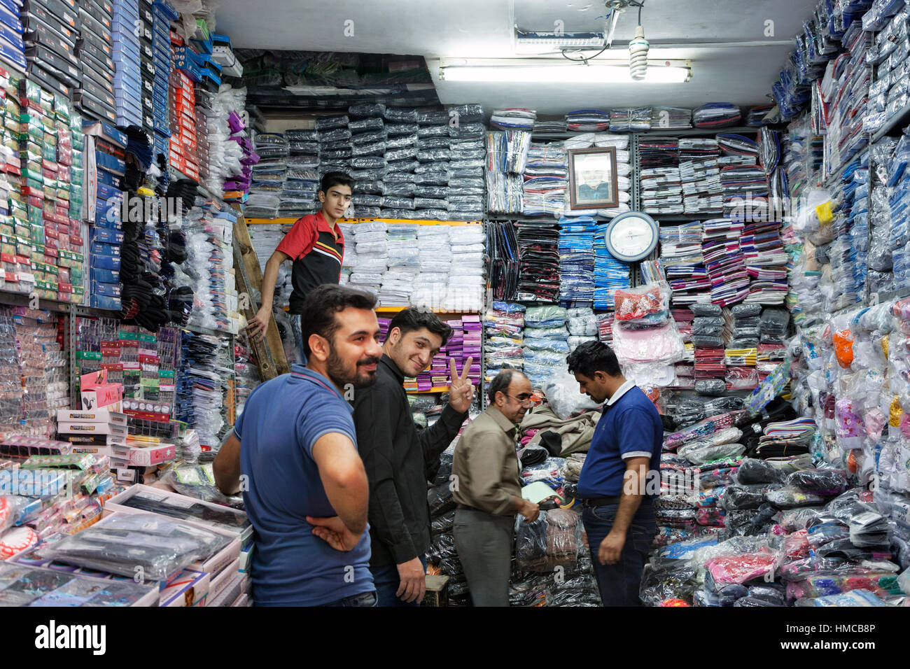 People inside a cloth shop, Isfahan bazaar, Iran Stock Photo