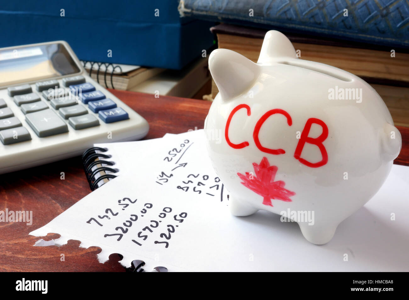 Piggy bank with word CCB. Canada child benefit concept. Stock Photo
