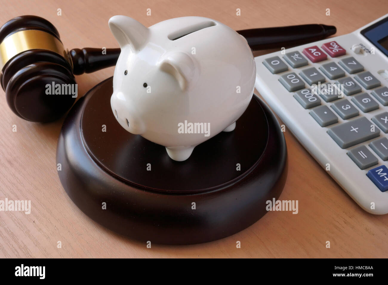 Piggy bank, gavel and calculator on a table Stock Photo - Alamy