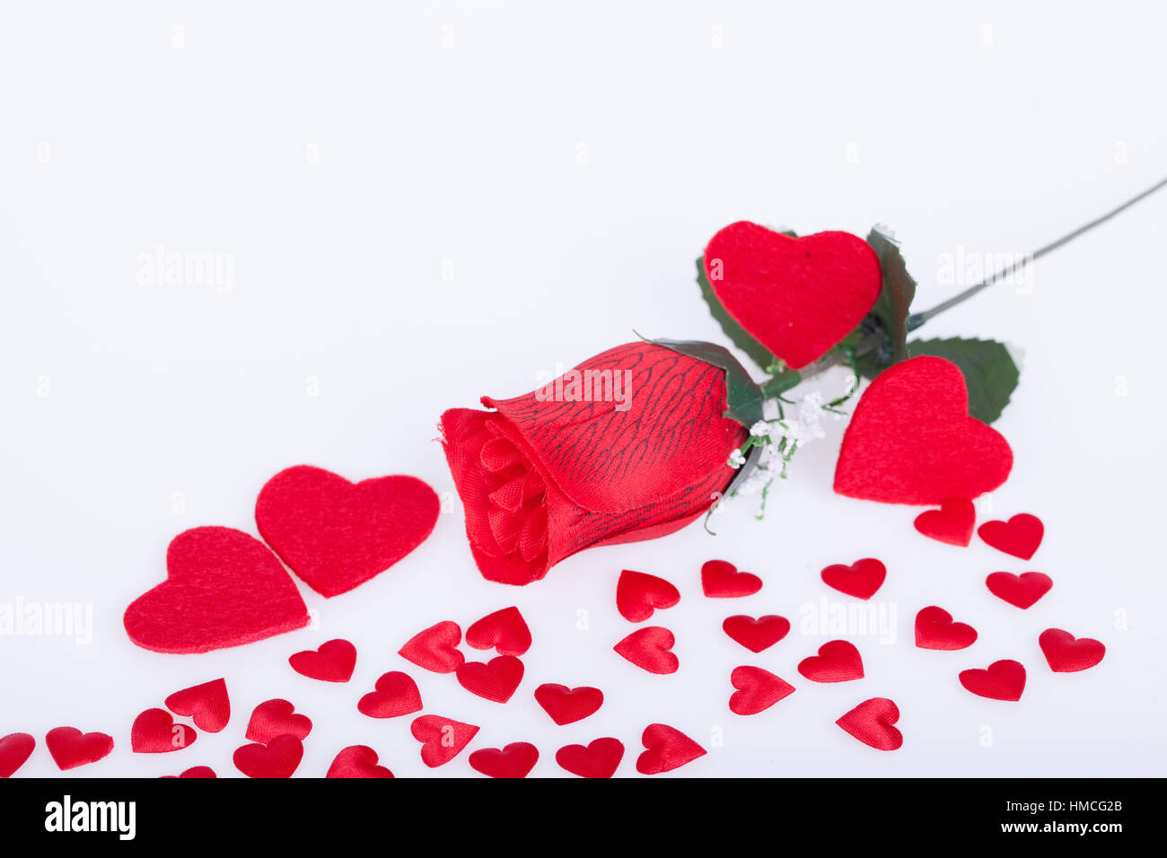 Red rose and red hearts on a white background Stock Photo - Alamy