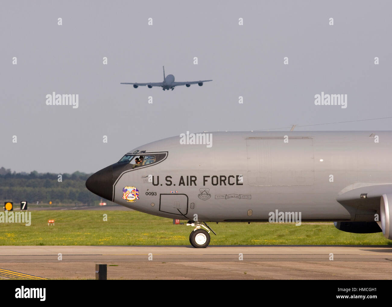 United States Air Force Boeing KC-135R Stratotanker 58-0093 taxies at RAF Mildenhall while another KC-135R 58-0036 takes off in the background. Stock Photo