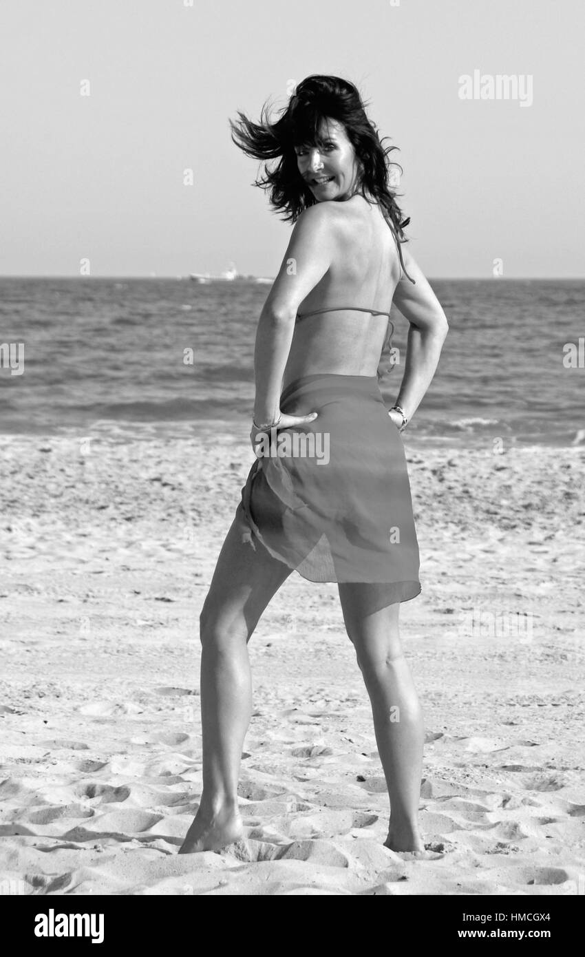 Beautiful young woman in a red bikini on the beach Stock Photo