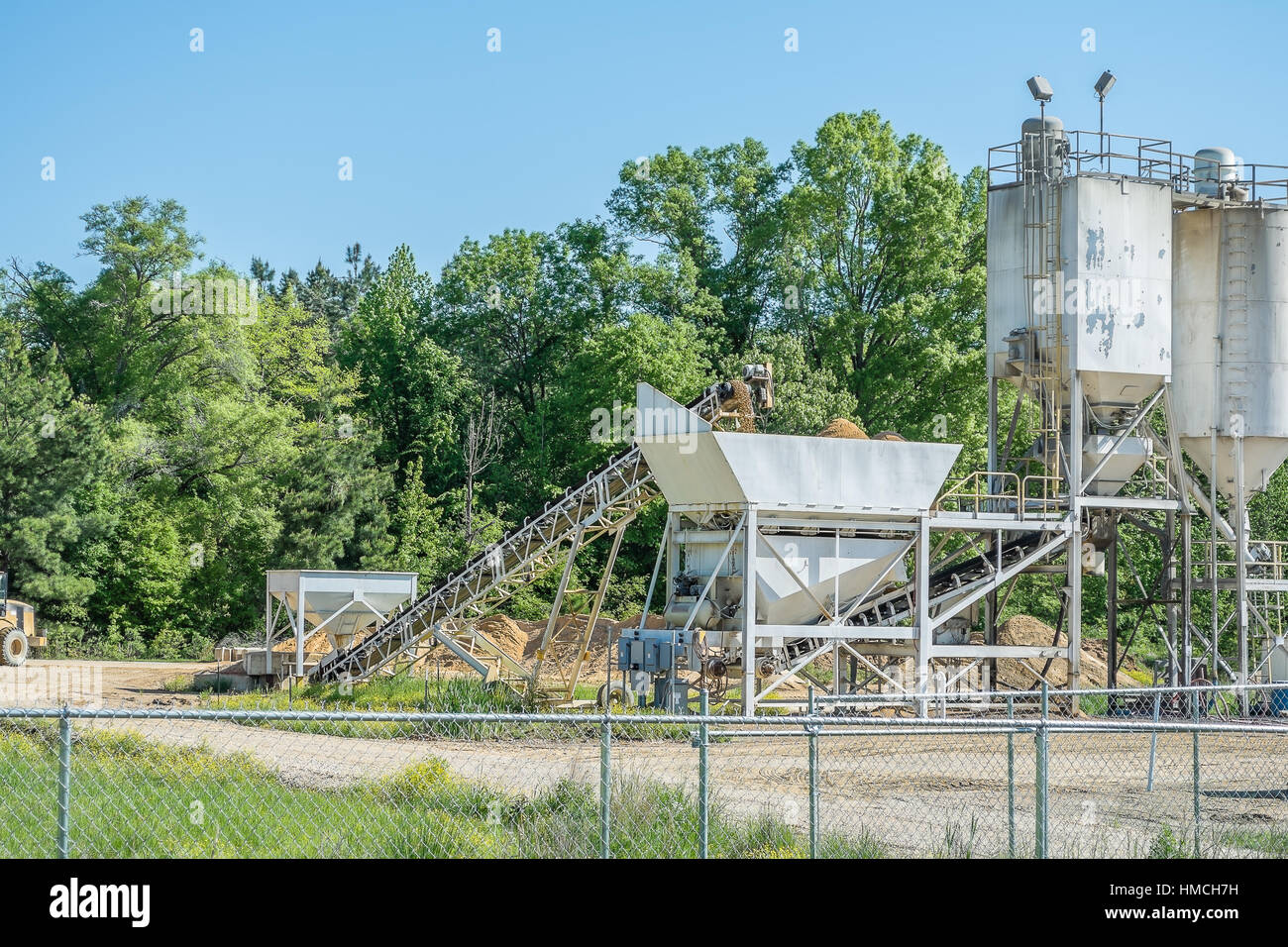 An industrial conveyor carrying large gravel rock to a crusher. The ...