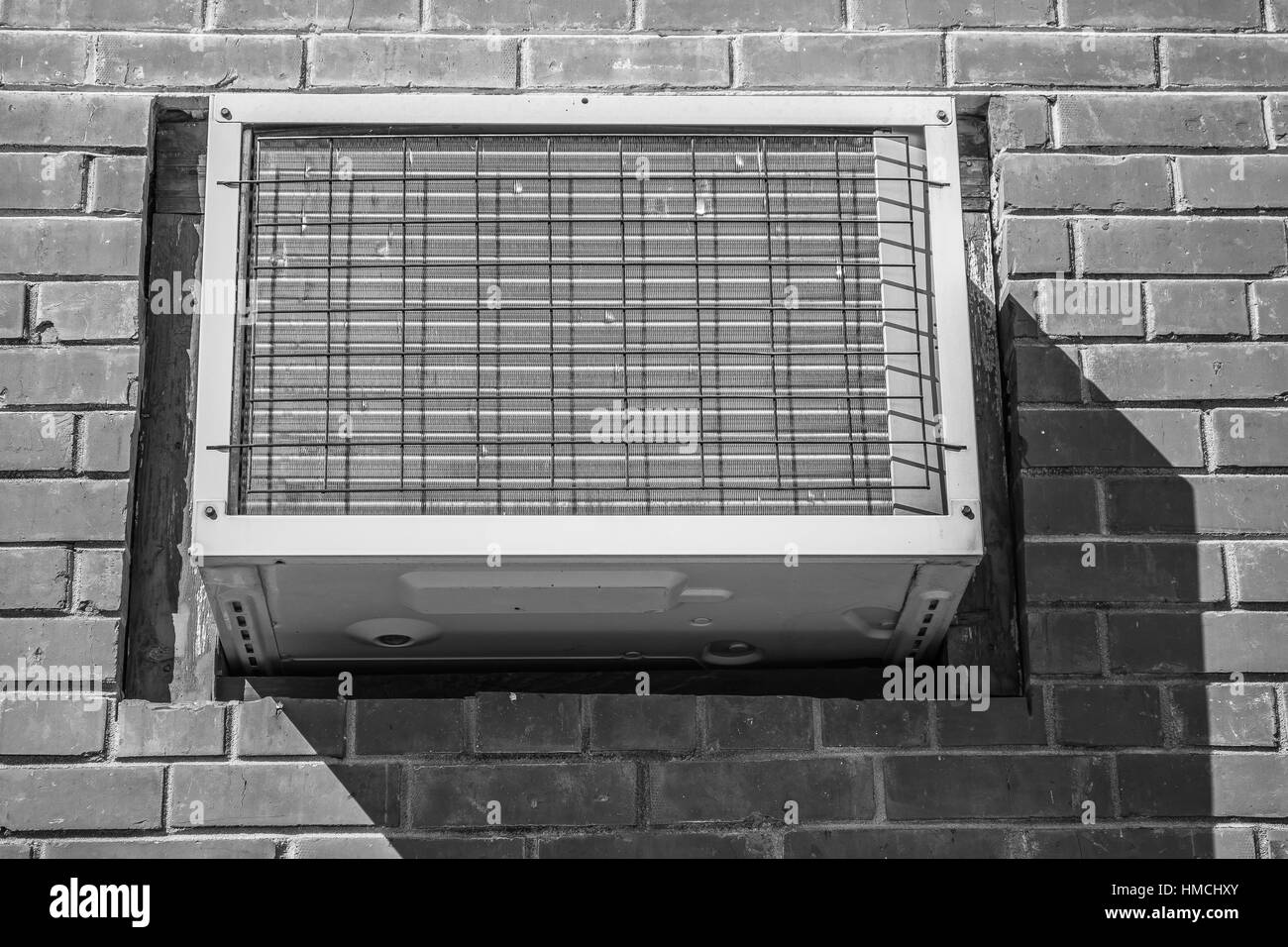 A black and white capture of a wall mounted air conditioner Stock Photo
