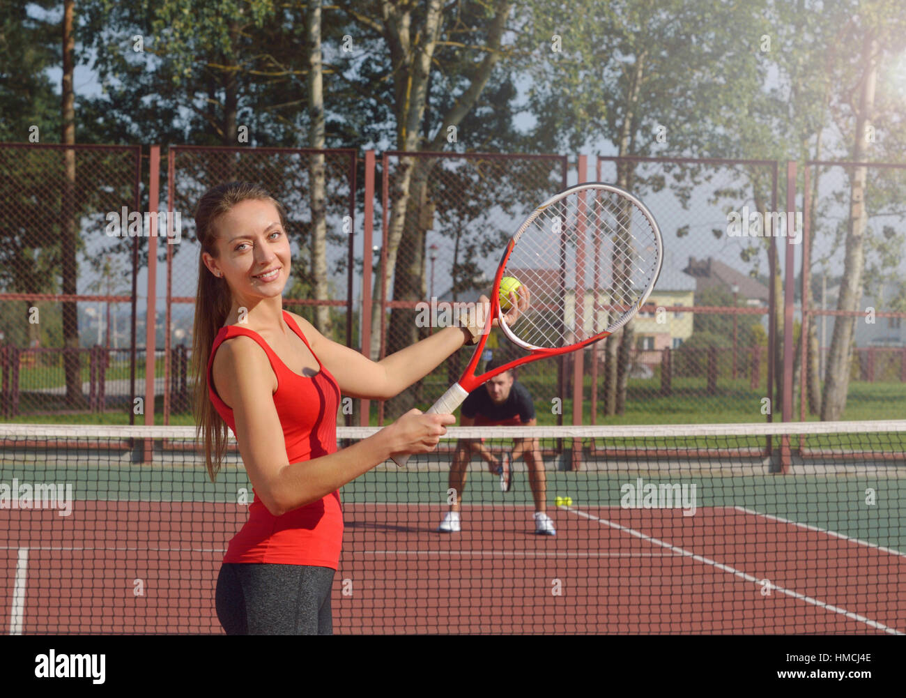 Woman playing tennis and preparing for sports competition. Women against men.Healthy fitness concept with active lifestyle. Stock Photo