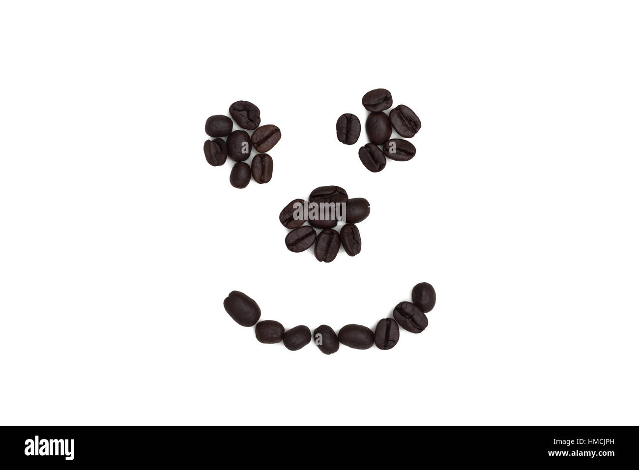A smiley face made from coffee beans on a white background Stock Photo