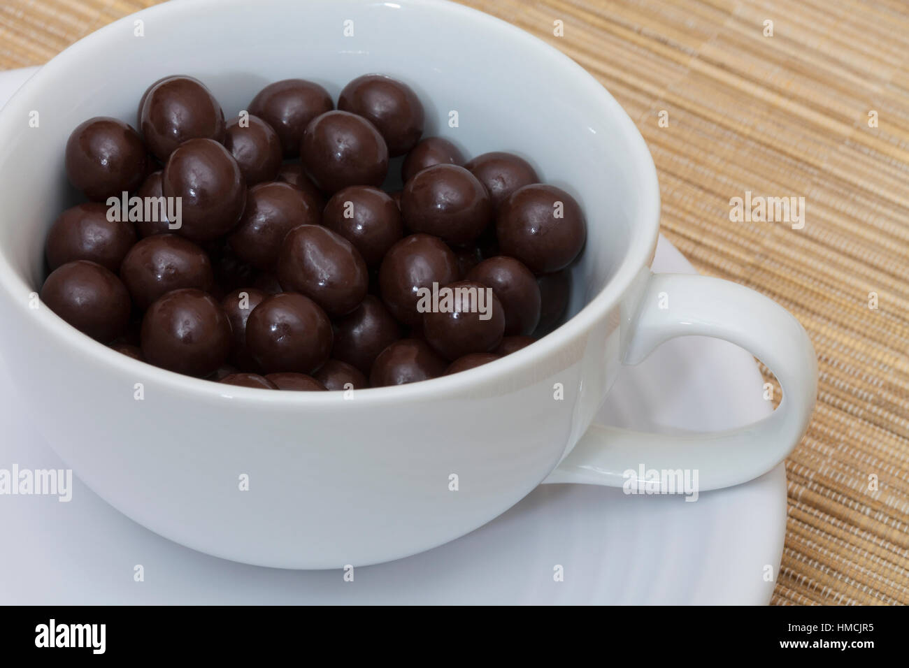 Chocolate covered espresso coffee beans in a cup Stock Photo