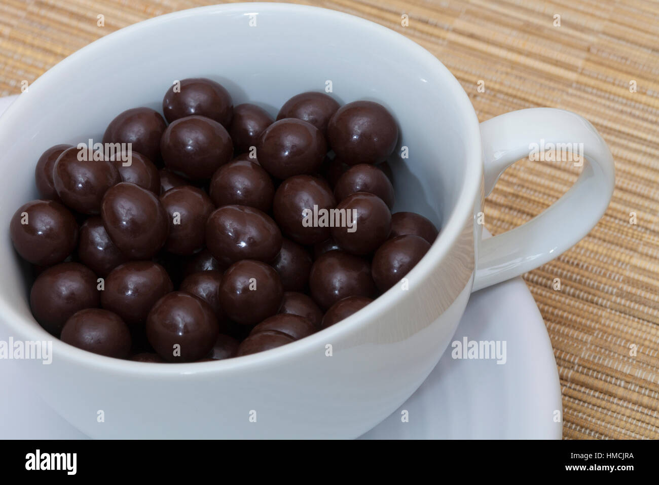 Chocolate covered espresso coffee beans in a cup Stock Photo