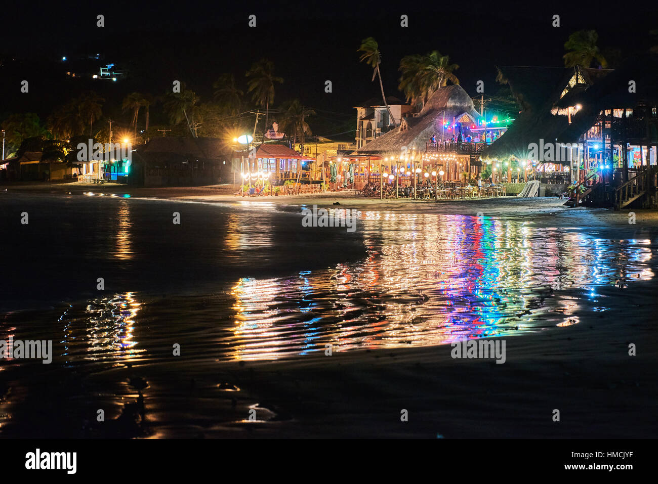 restourants lights on beach at night in tropics Stock Photo