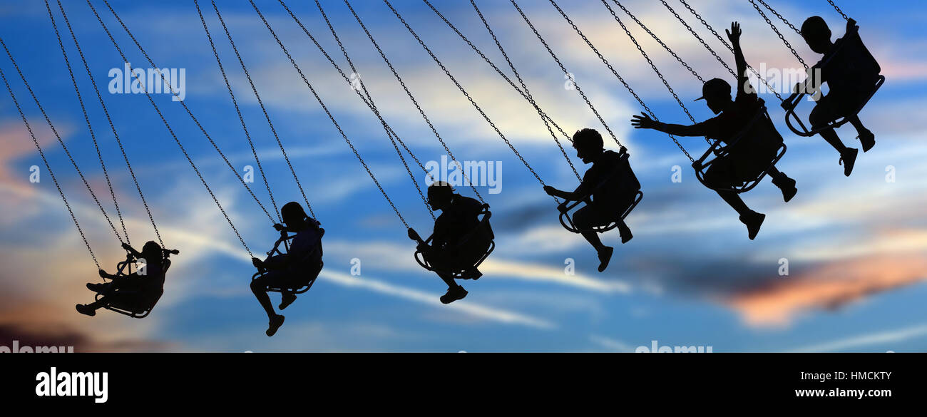Kid on a carnival ride with sky in background Stock Photo - Alamy
