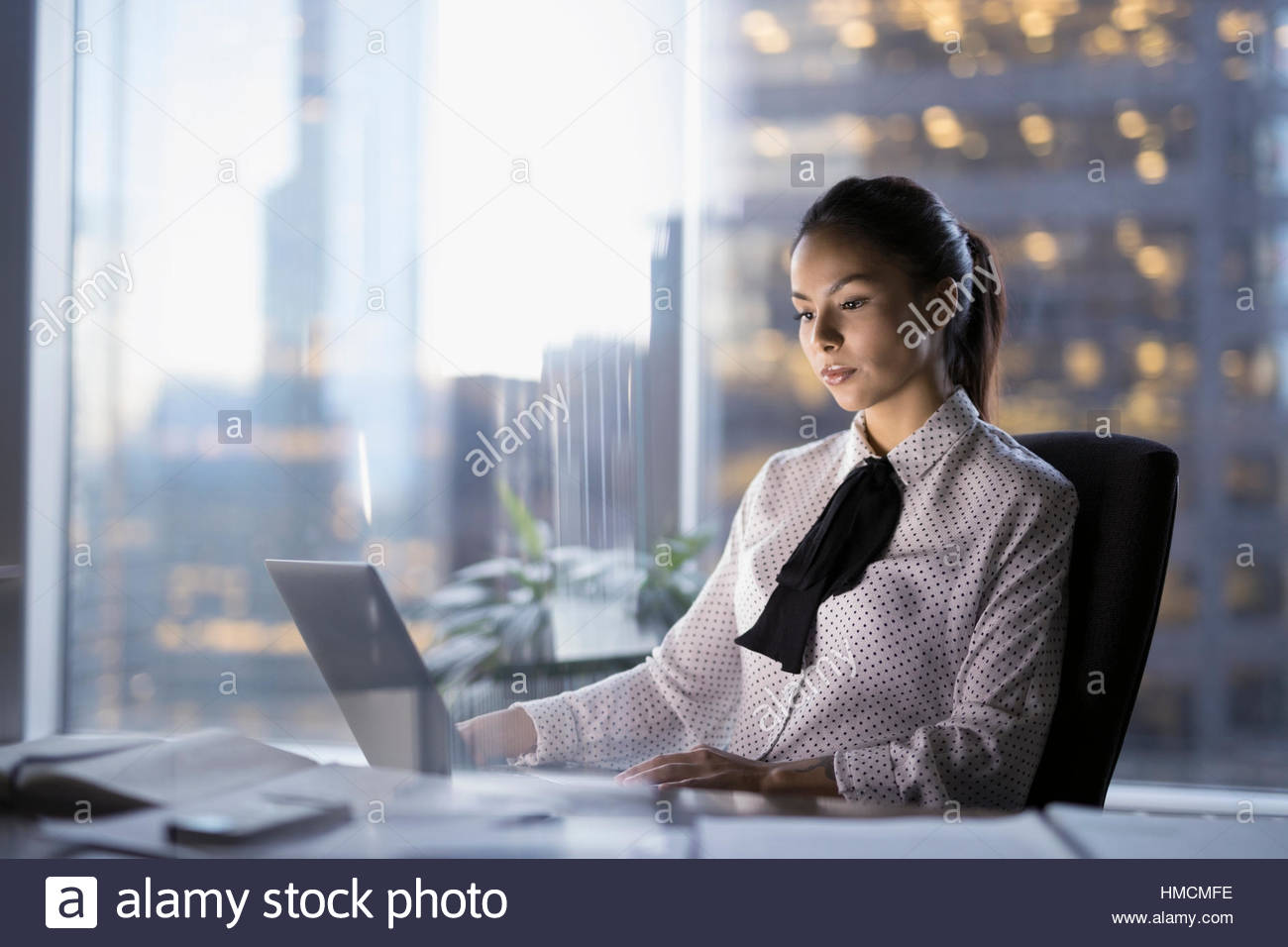 Female lawyer working late at laptop in urban office Stock Photo Alamy