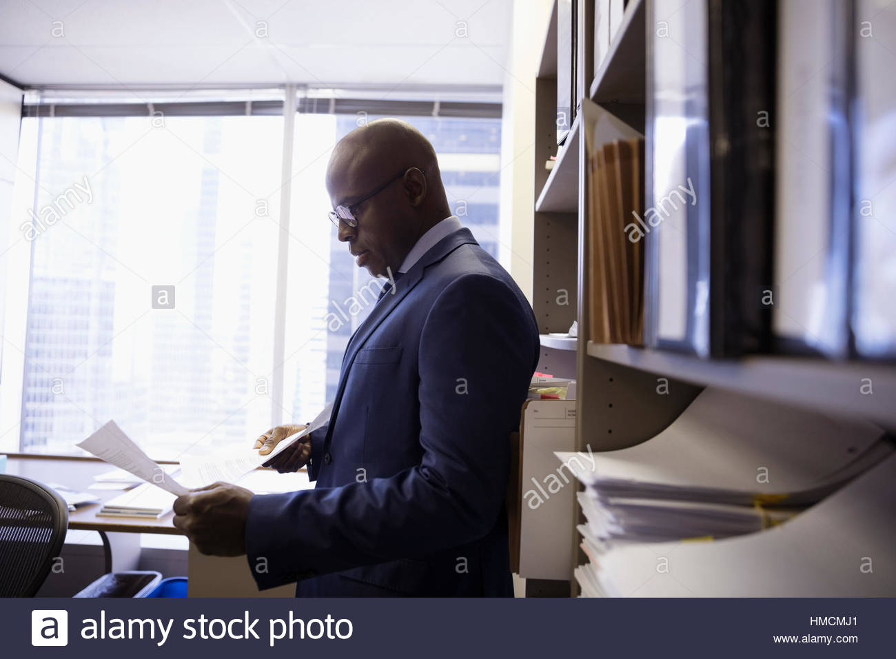Male lawyer reviewing paperwork in office Stock Photo