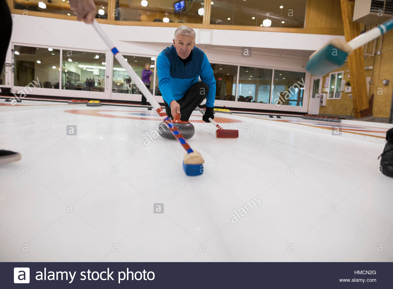 Senior man curling Stock Photo