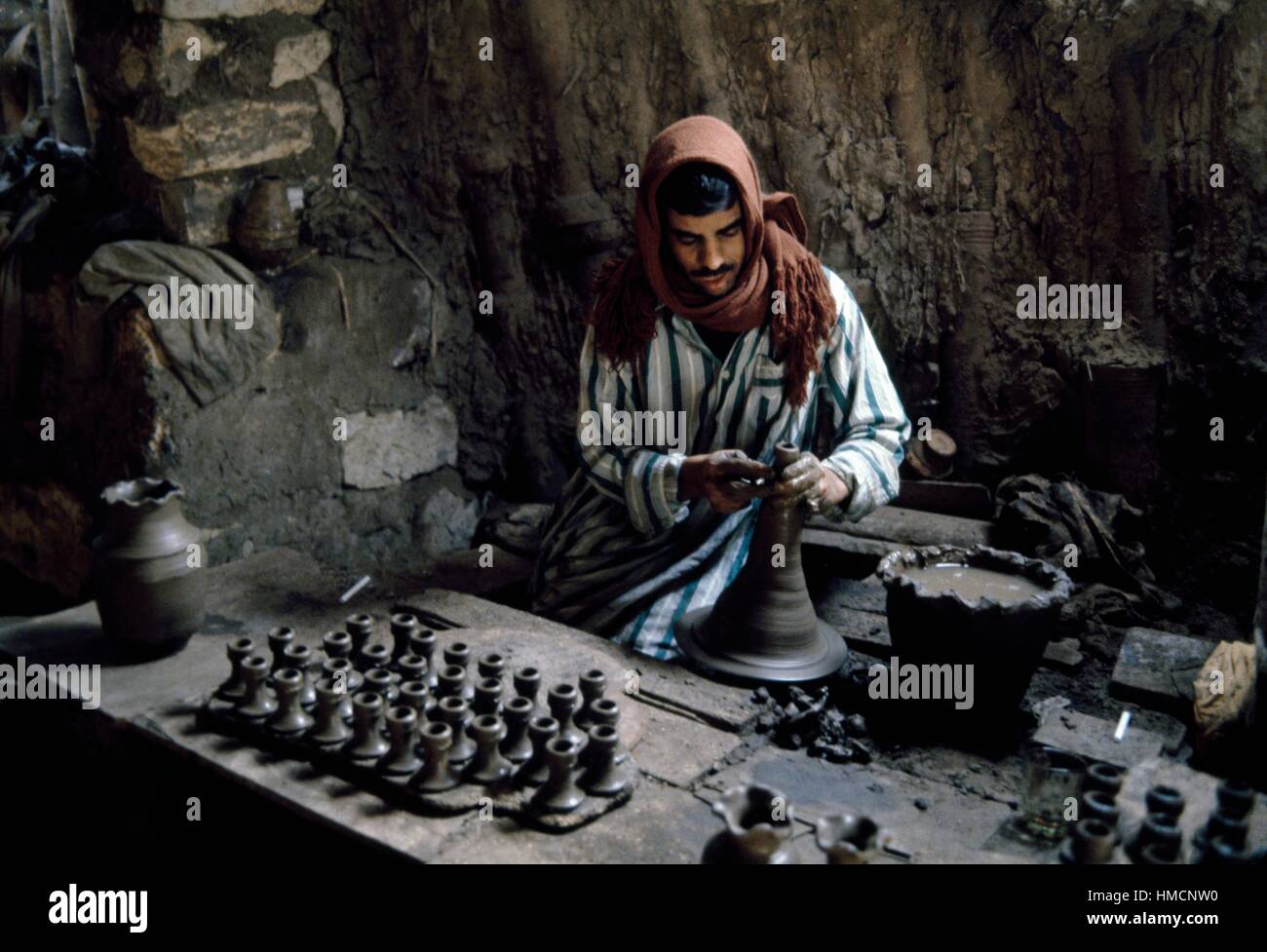 Modelling clay on a pottery wheel in the potters' district of Al Fustat, Cairo, Egypt. Stock Photo