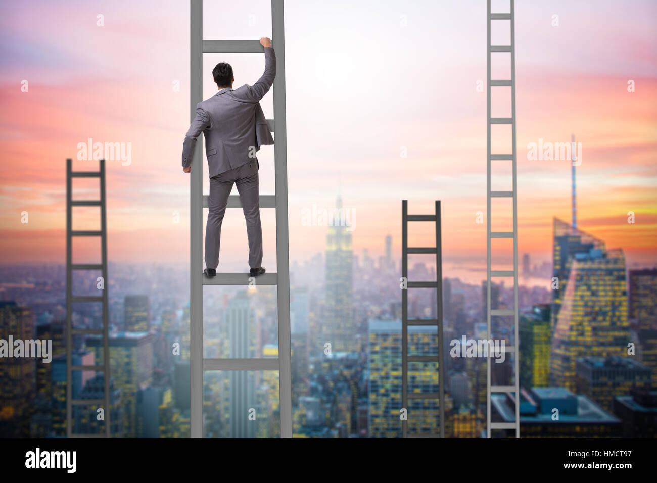 Young businessman climbing career ladder Stock Photo - Alamy