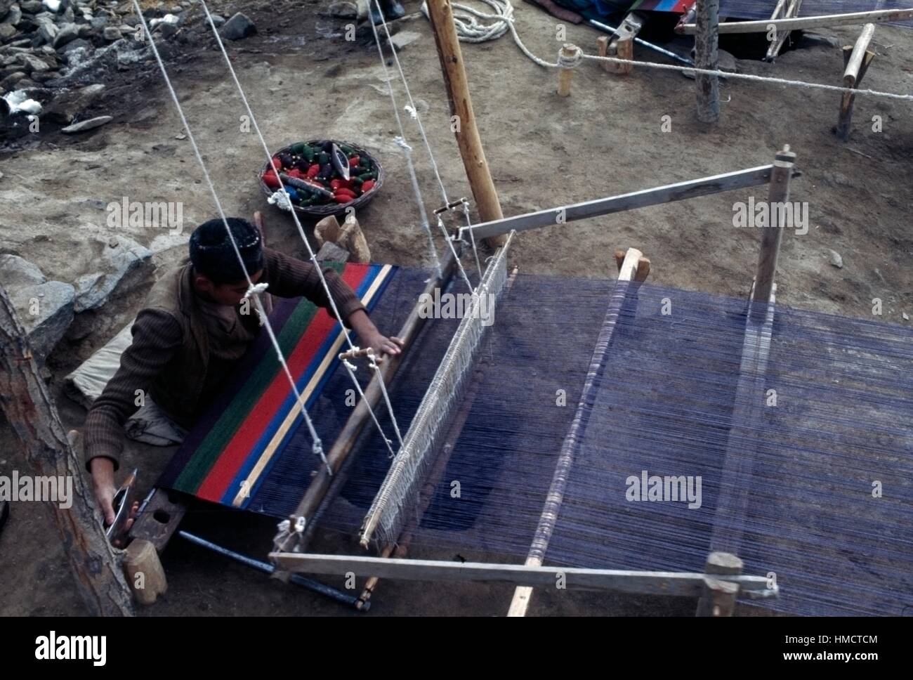 Man weaving cotton mats on a loom, Istalif, Afghanistan. Stock Photo