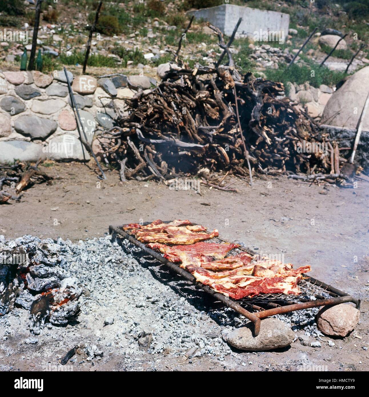 Cooking asado, grilled meat, traditional Argentine dish, Argentina