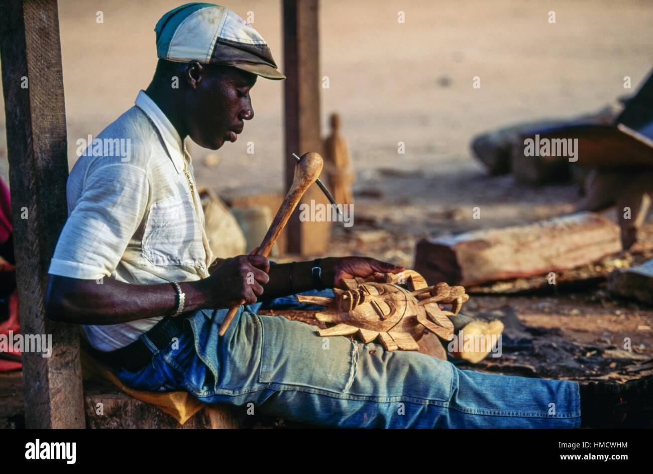 A Senufo artisan carving wood, Ivory Coast Stock Photo Alamy