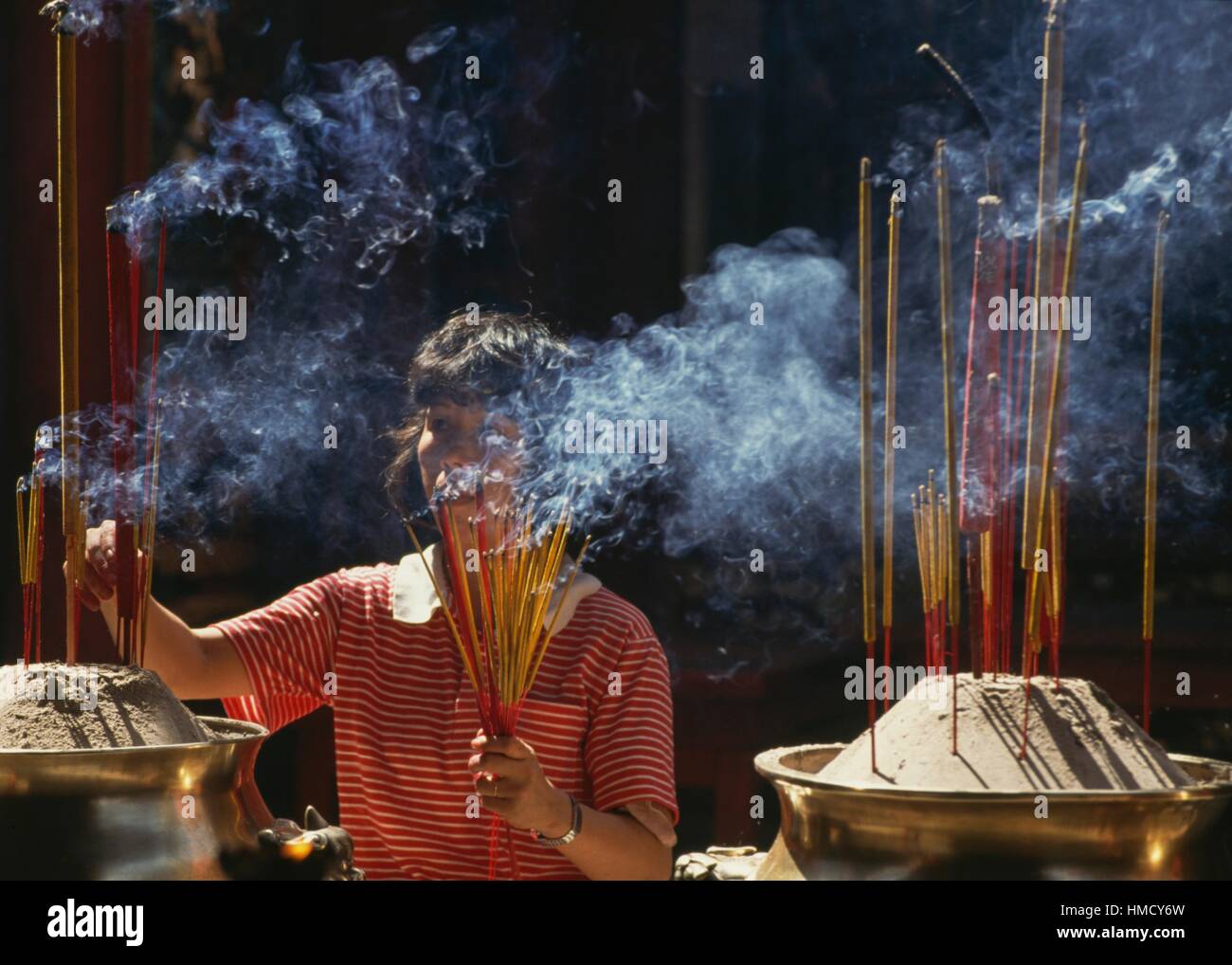 Black woman lighting incense stick hi-res stock photography and images ...