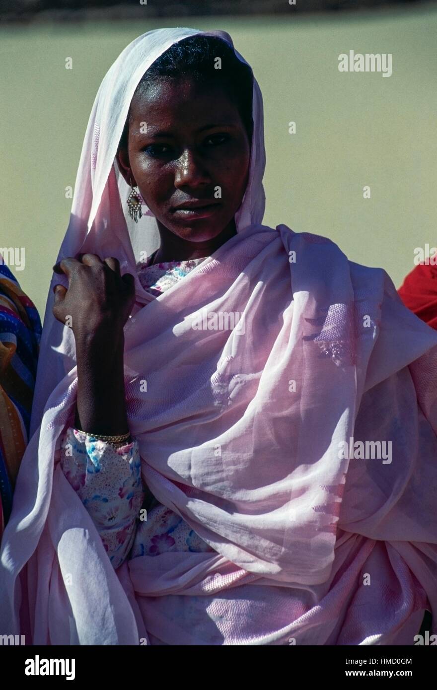 Young woman with a pink veil near the Pyramids of the black pharaoh at Nuri, Sudan. Stock Photo