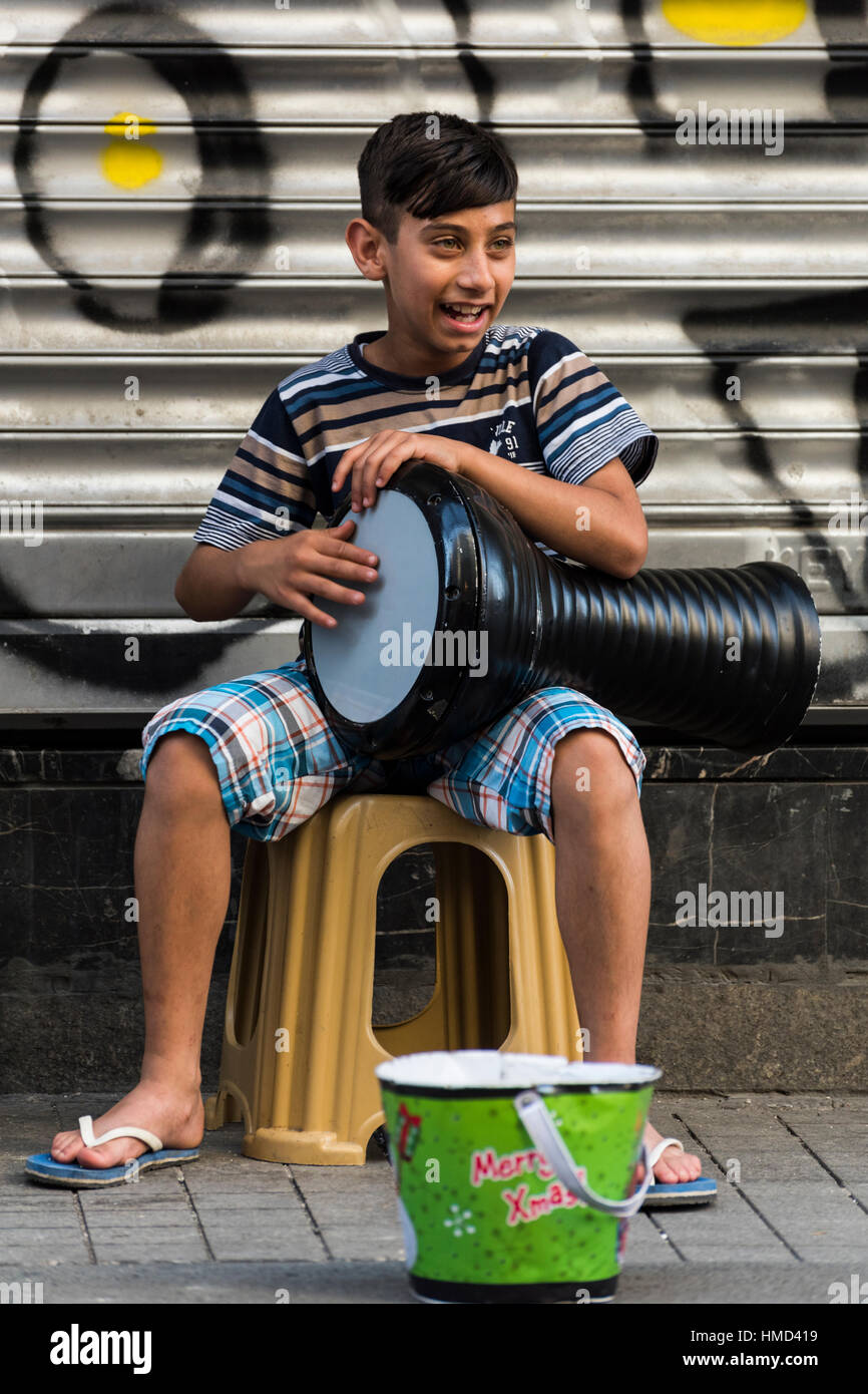 Istanbul, Turkey - June 18, 2016: Young street musician performing with his instrument in Istiklal Avenue, Istanbul. Known in English as Independence Stock Photo