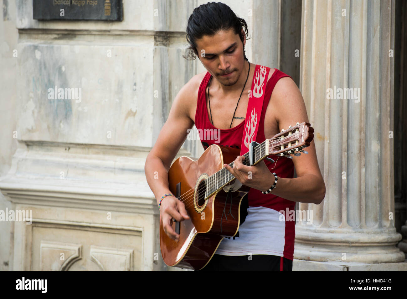 Istanbul, Turkey - June 18, 2016: Young street musician performing with his instrument in Istiklal Avenue, Istanbul. Known in English as Independence Stock Photo