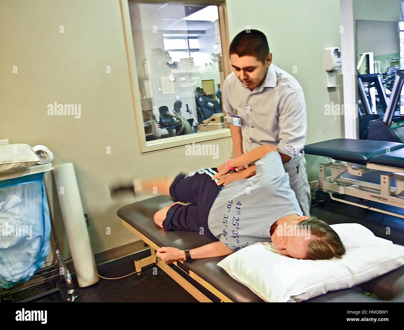 A physical therapist works on a patient following knee replacement