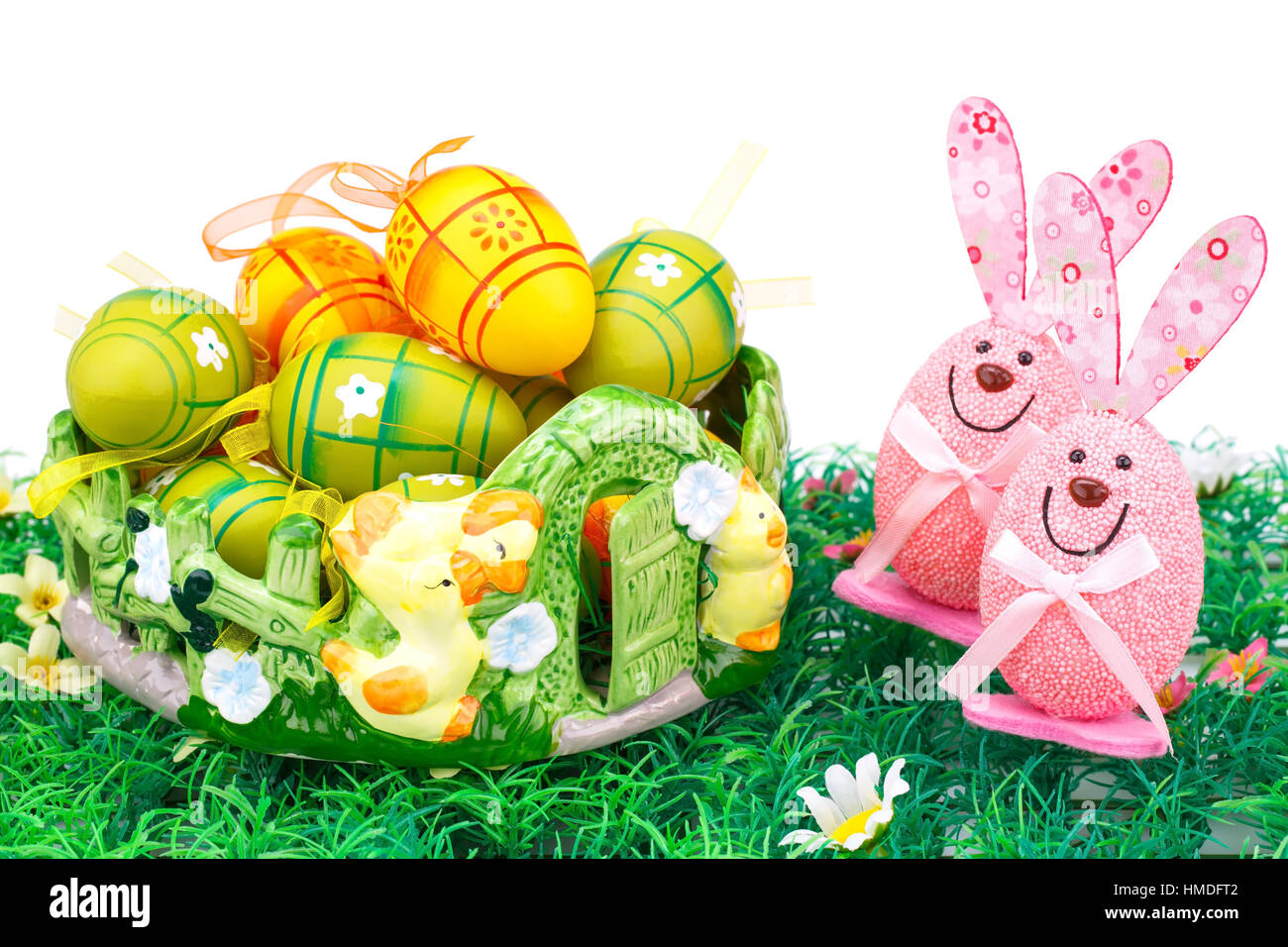 Easter decoration with colorful eggs in basket and bunnies on ...