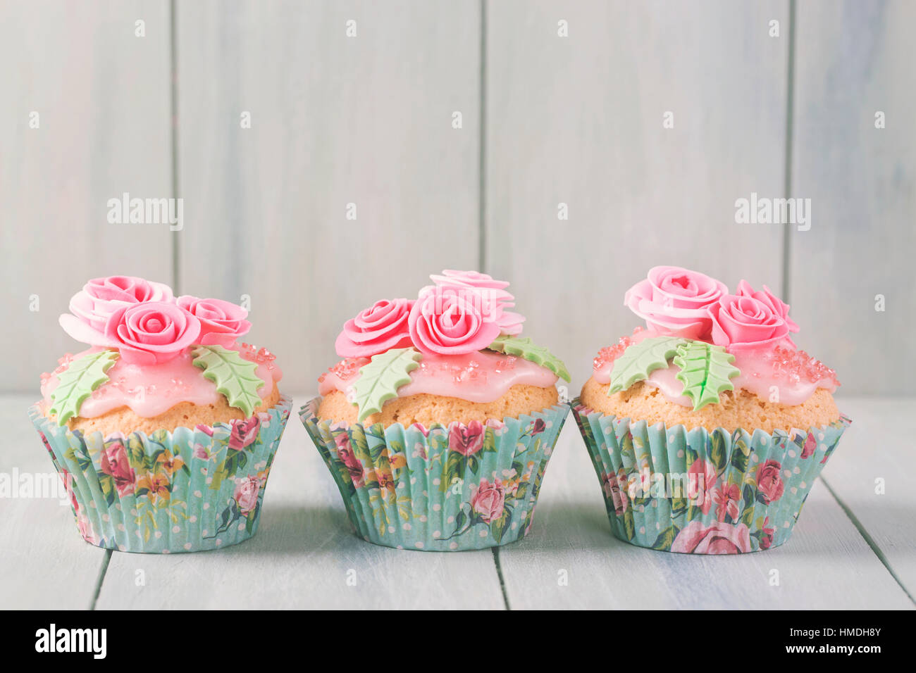 Pastel colored cupcakes with roses Stock Photo Alamy