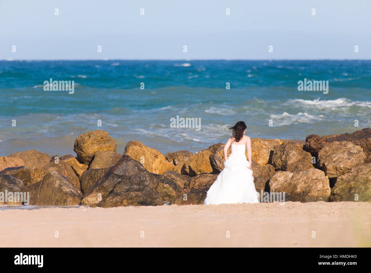 Woman Dressed In Wedding On The Beach Cullera Valencia Spain Stock