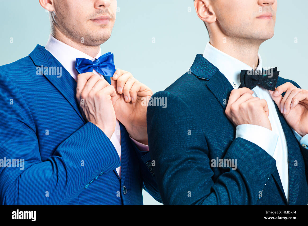 Portrait of handsome and elegant business men wearing bow tie and suits ...