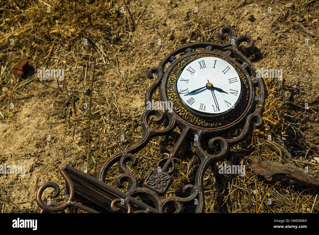 An old clock in the dirt Stock Photo