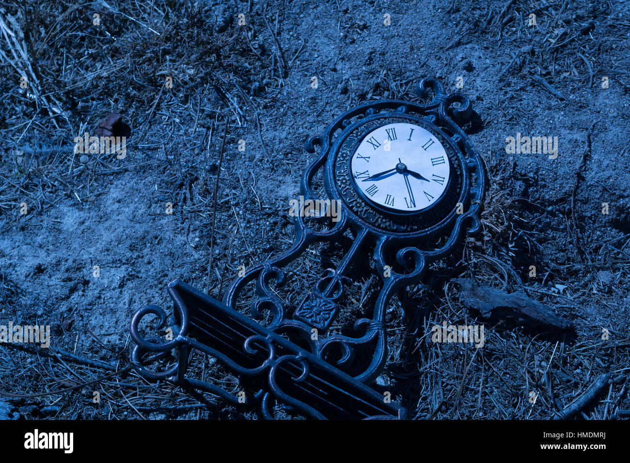 An old clock in the dirt Stock Photo