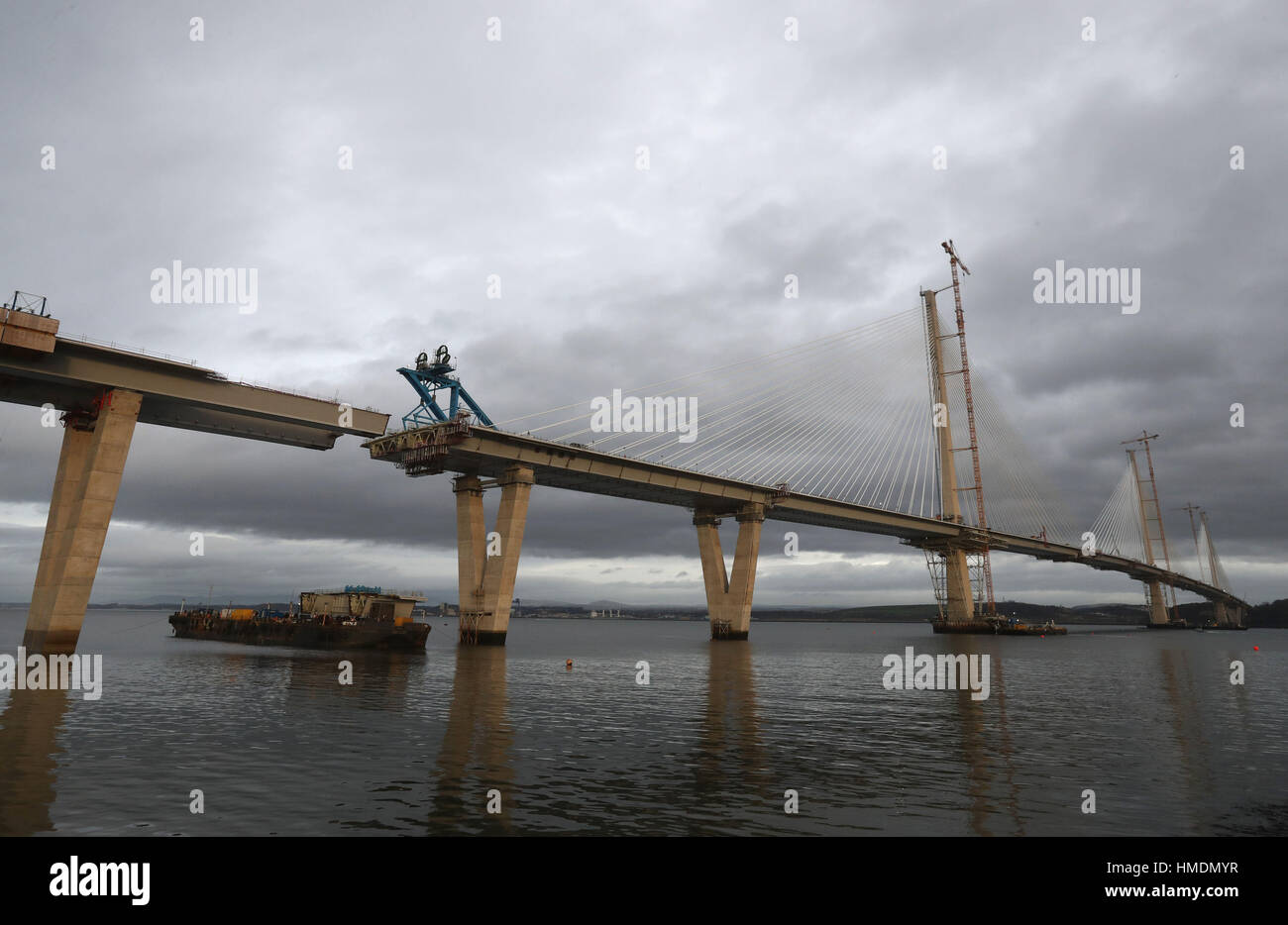 The final deck piece of the Queensferry Crossing over the Firth of Forth, sits on a barge ahead of it being lifted into position. Once the operation to start the lift begins, it will take around four hours to complete. Stock Photo