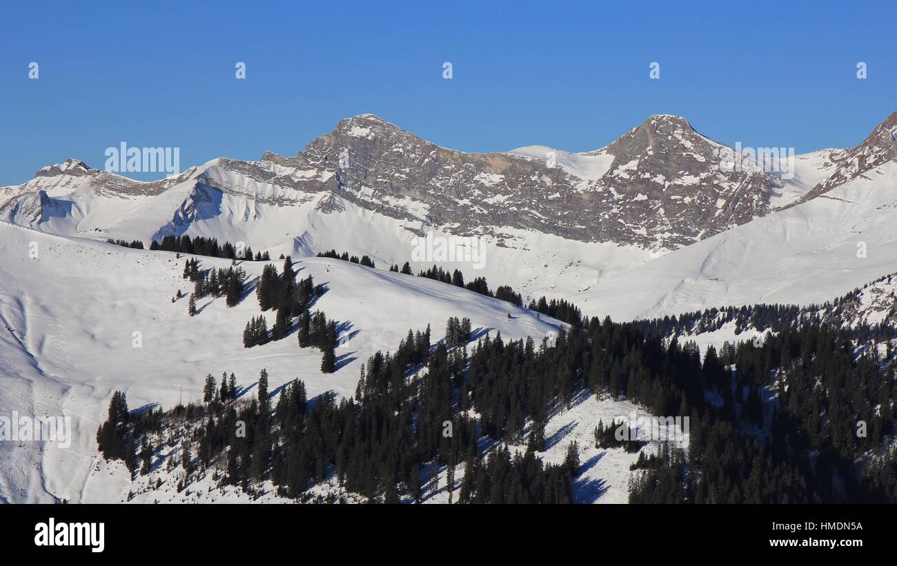 Snow covered mountain range in the Swiss Alps. Mount Vanil Noir and other peaks seen from the Rellerli ski area. Stock Photo