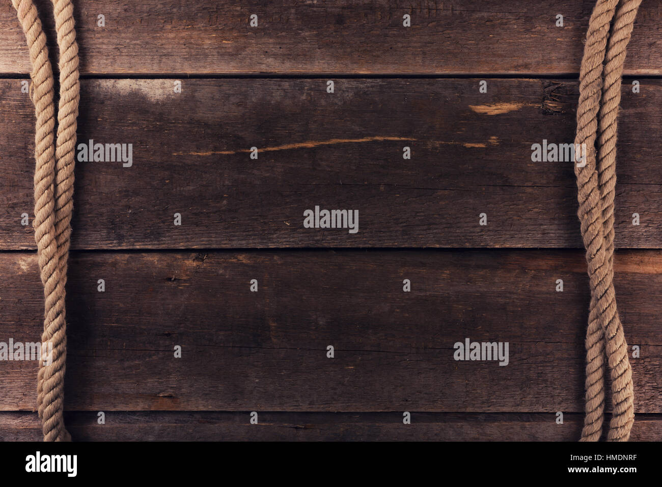 weathered ship ropes on old wooden plank background Stock Photo