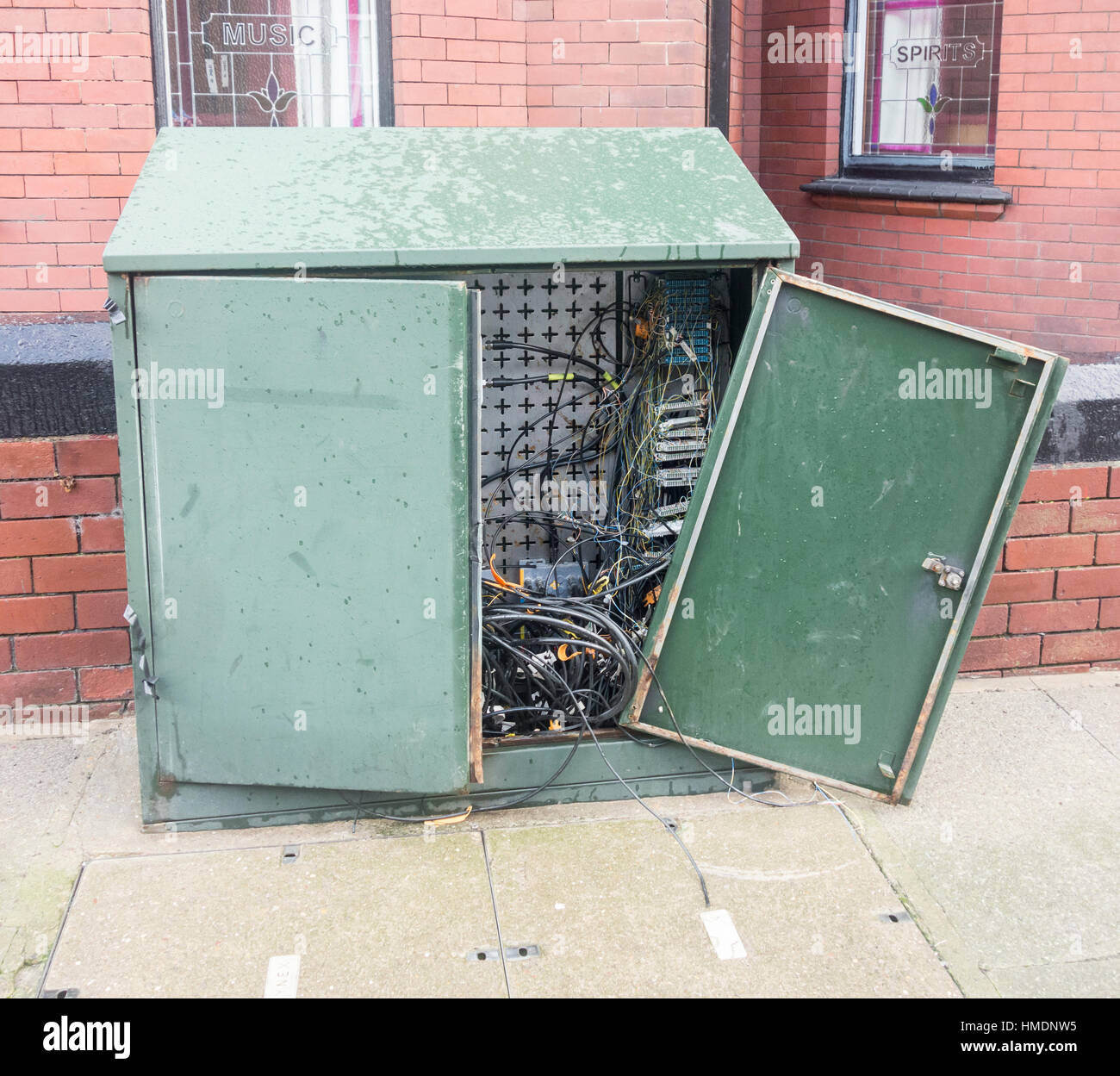 Vandalized BT junction box in street. UK Stock Photo