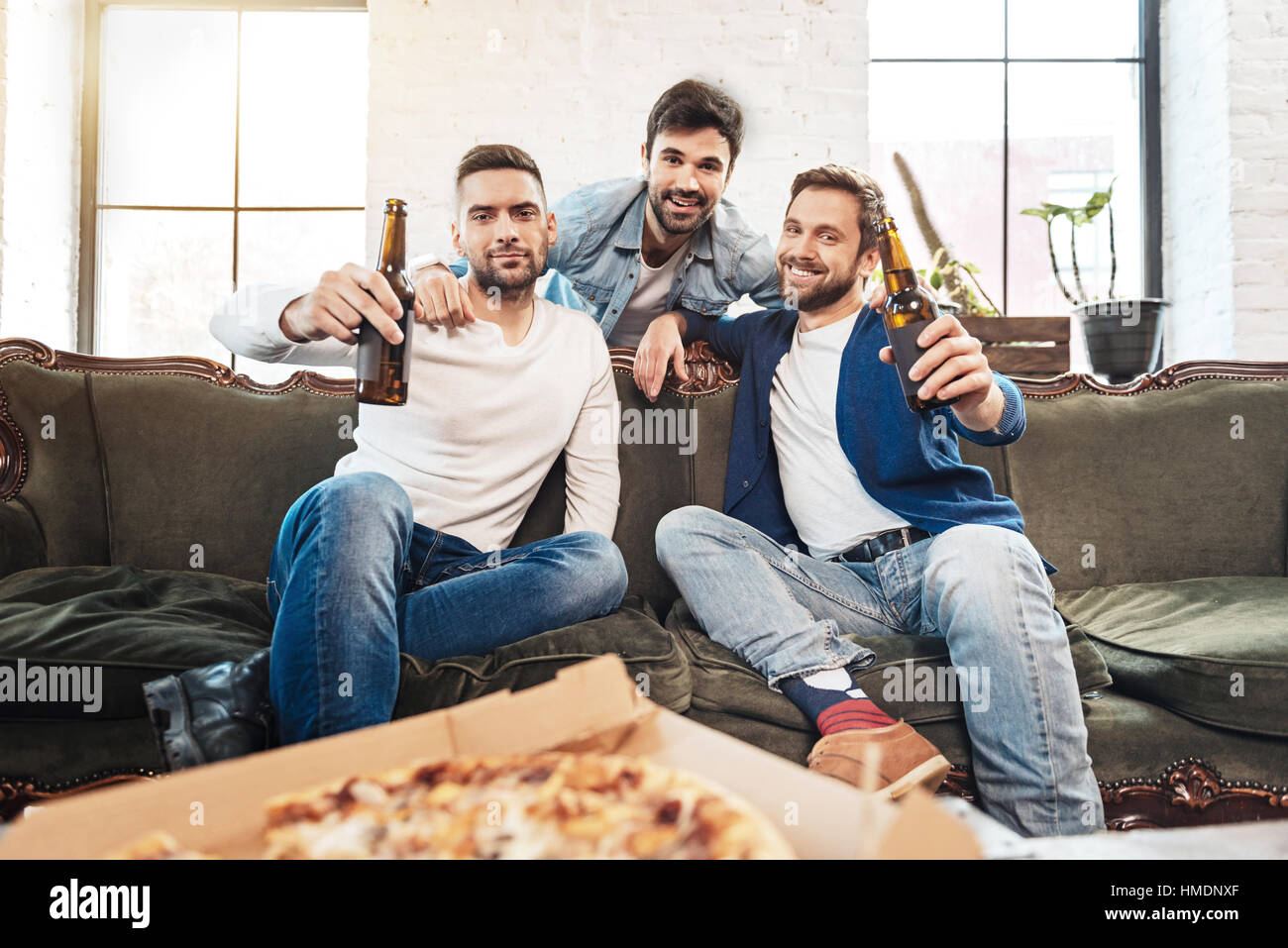 Happy bearded man hugging his friends Stock Photo - Alamy
