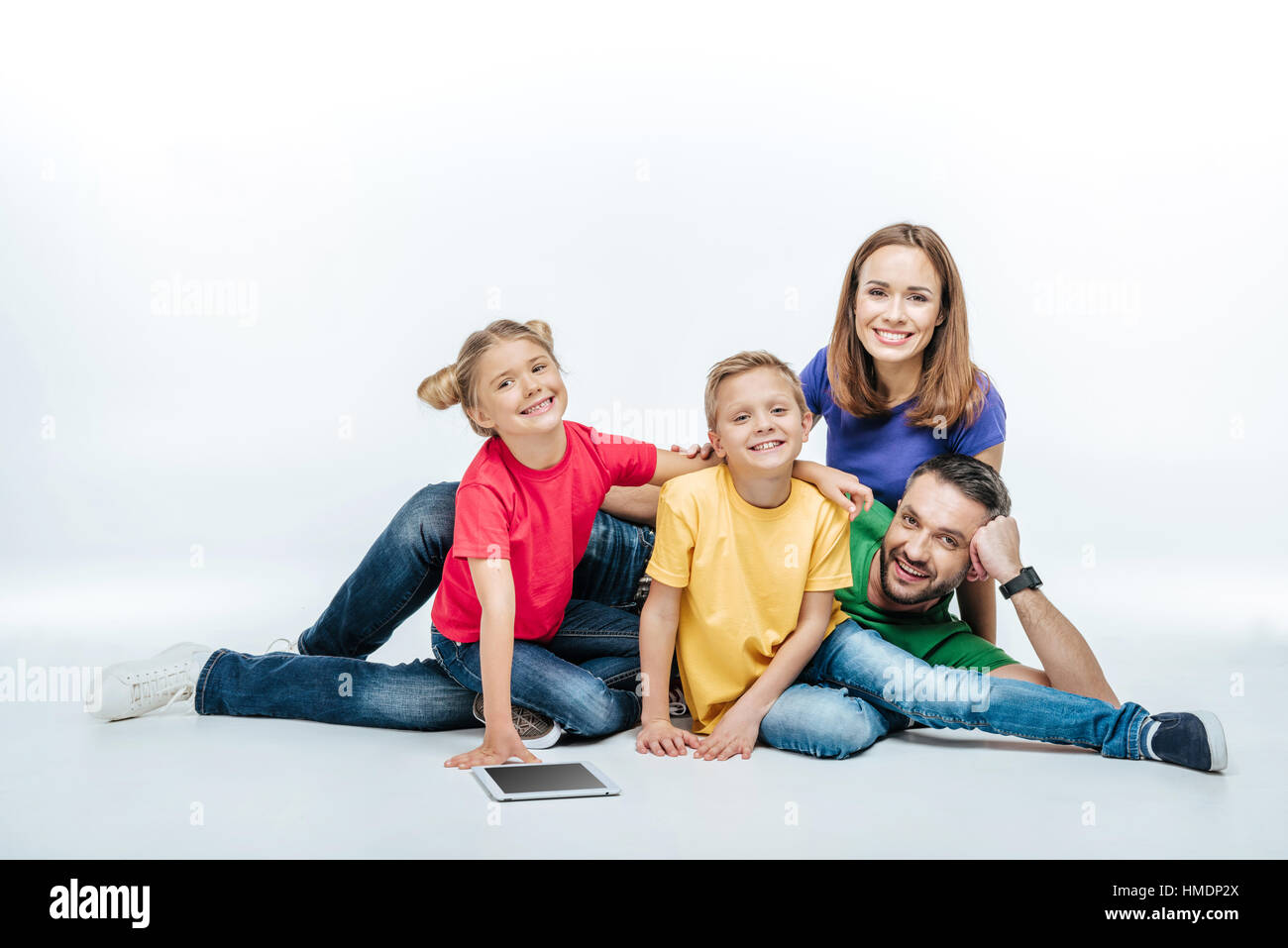 family lying together with digital tablet Stock Photo