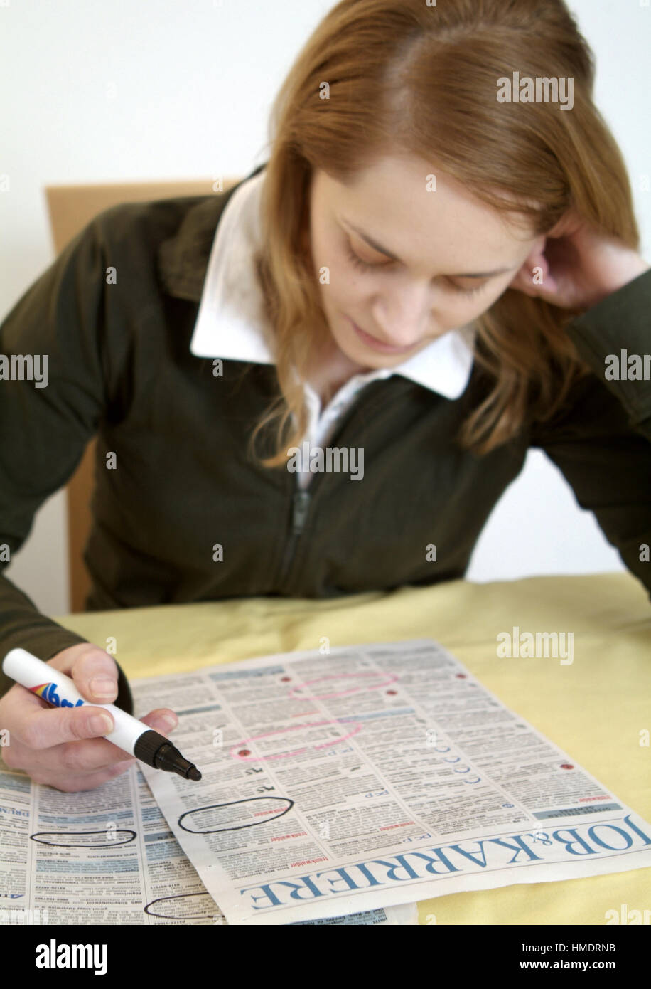 Jobless woman reading appointments section Stock Photo