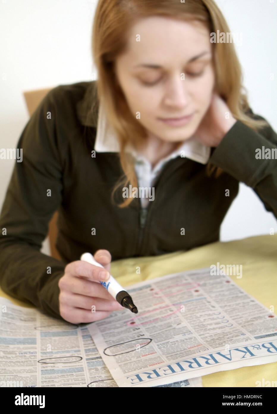 Jobless woman reading appointments section Stock Photo